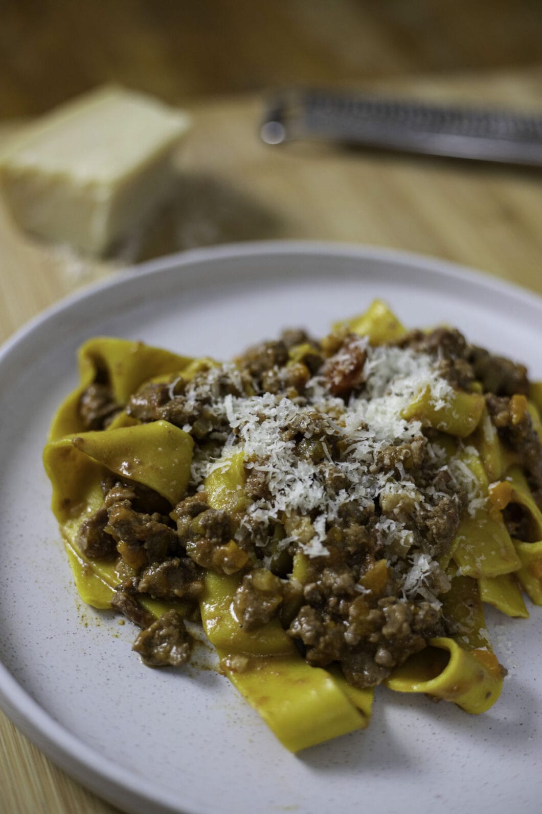 Authentic parpardelle alla bolognese with grated parmesan