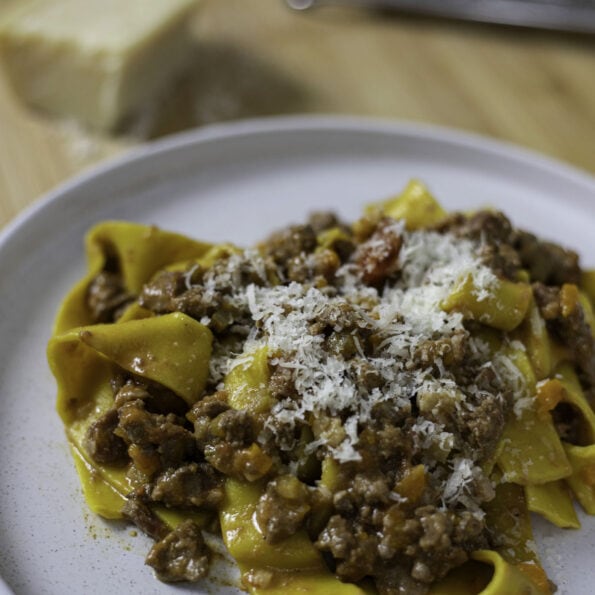 Authentic parpardelle alla bolognese with grated parmesan