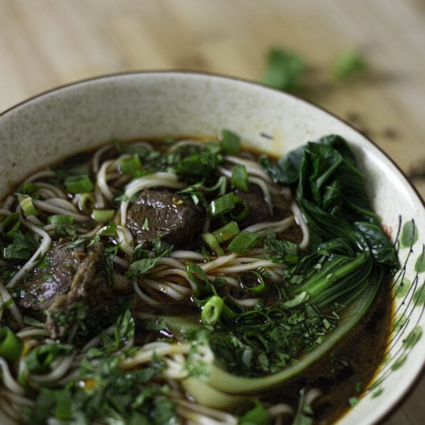 Spicy Szechuan noodle beef soup with pak choi