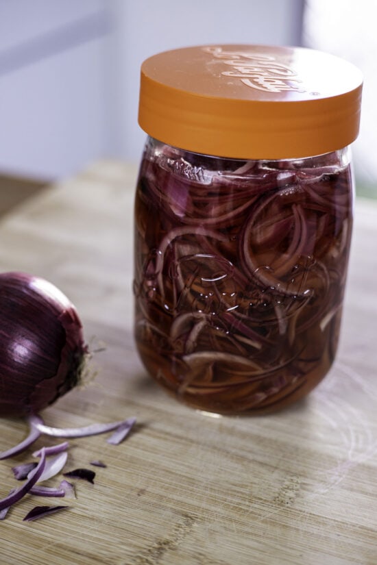 Pickled red onions in a jar