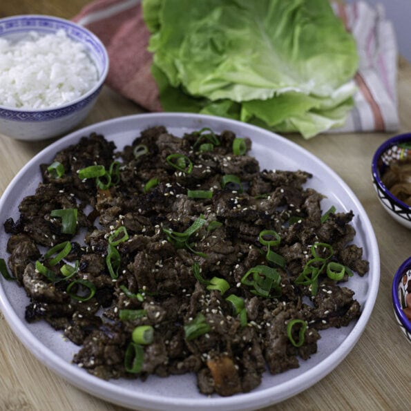 Beef bulgogi with rice, salad leaves and condiments