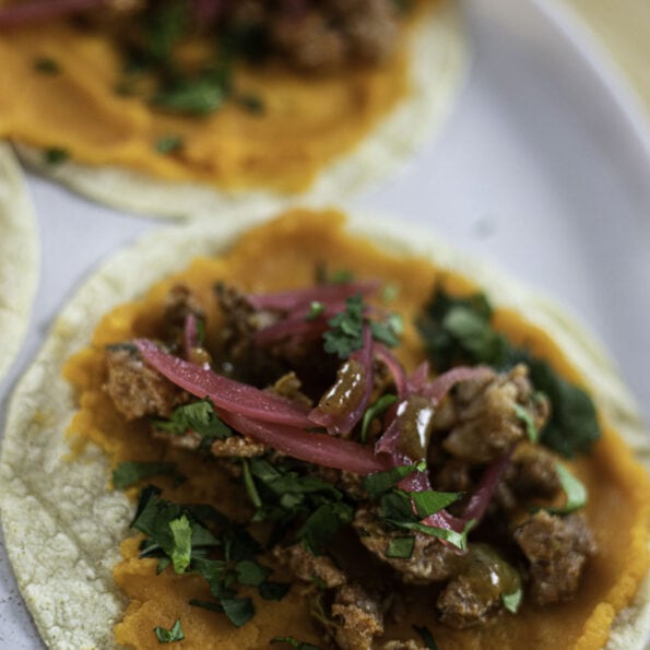 Sweet potato and crumbled chorizo tacos with cilantro and pickled onions