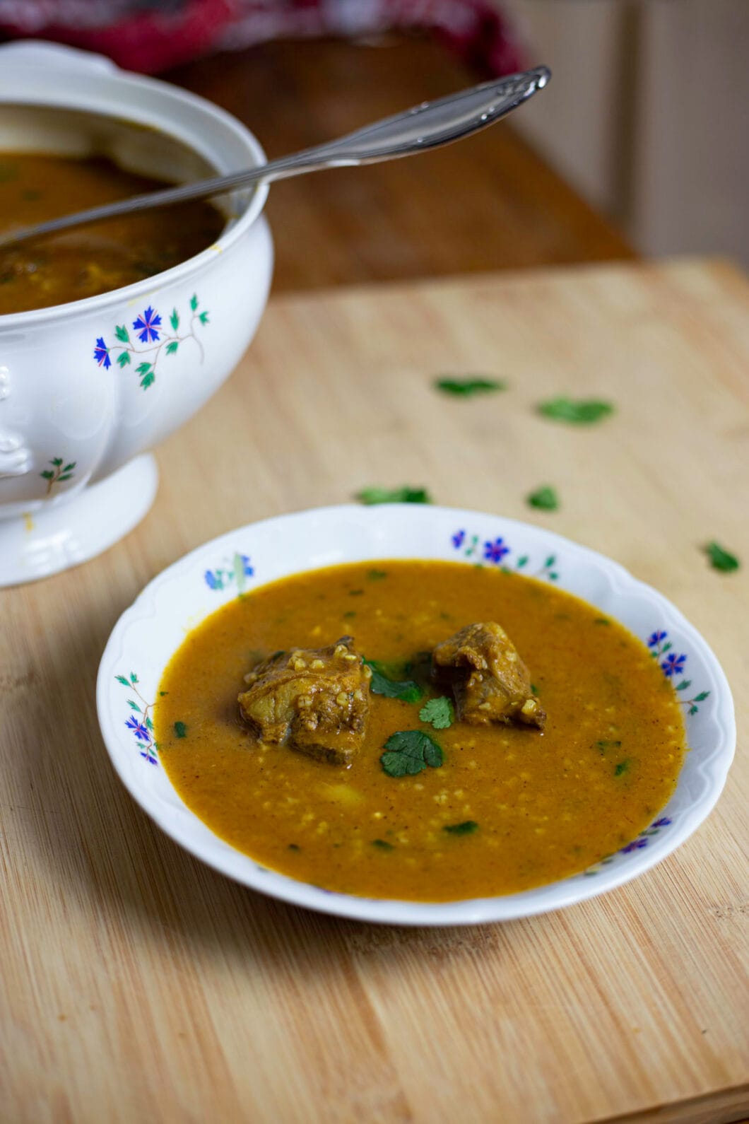 Bowl of orange soup (chorba frik) with cilantro