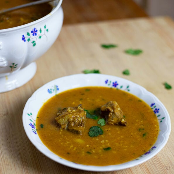 Bowl of orange soup (chorba frik) with cilantro