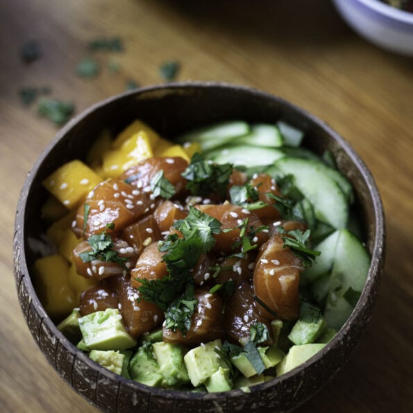 Poke bowl with salmon, cucumber, avocado and mango