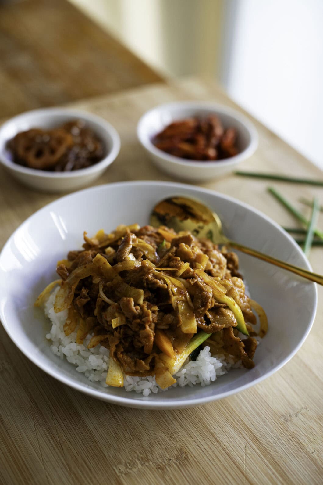 Spicy stir-fried pork with gochujang sauce over rice