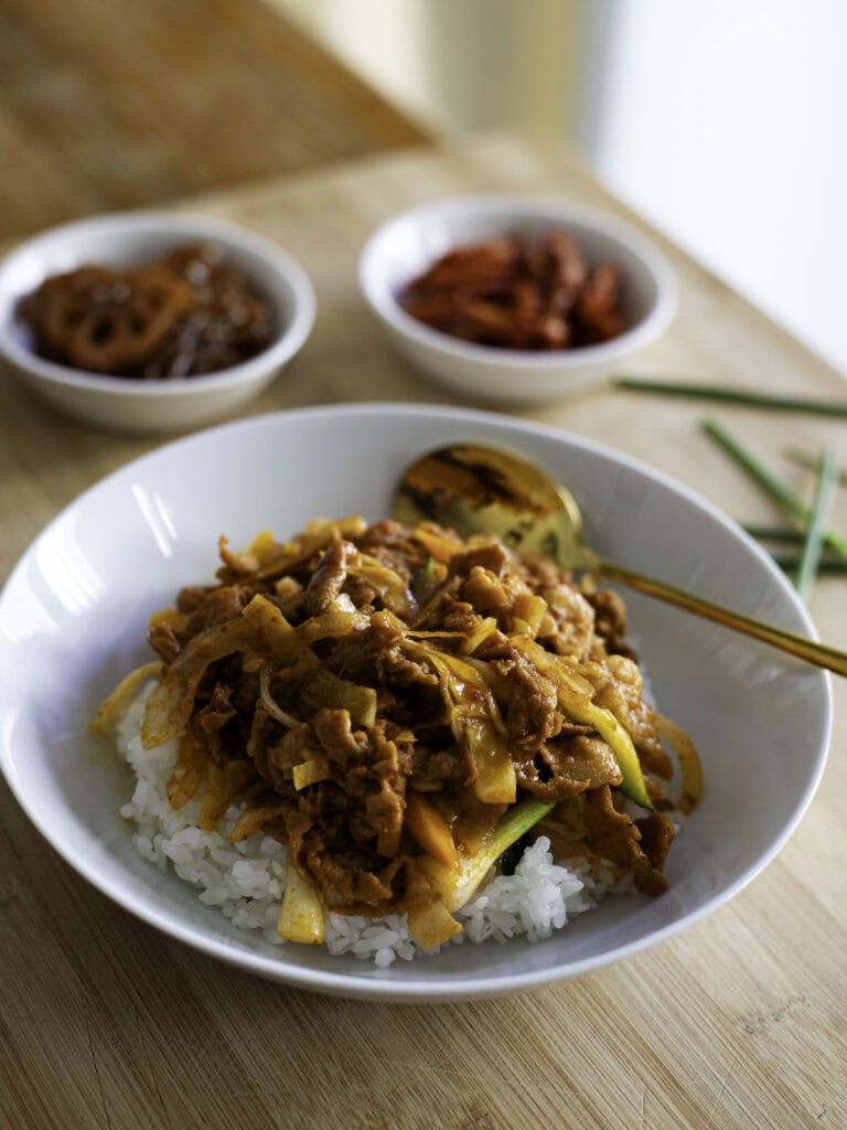 Spicy stir-fried pork with gochujang sauce over rice