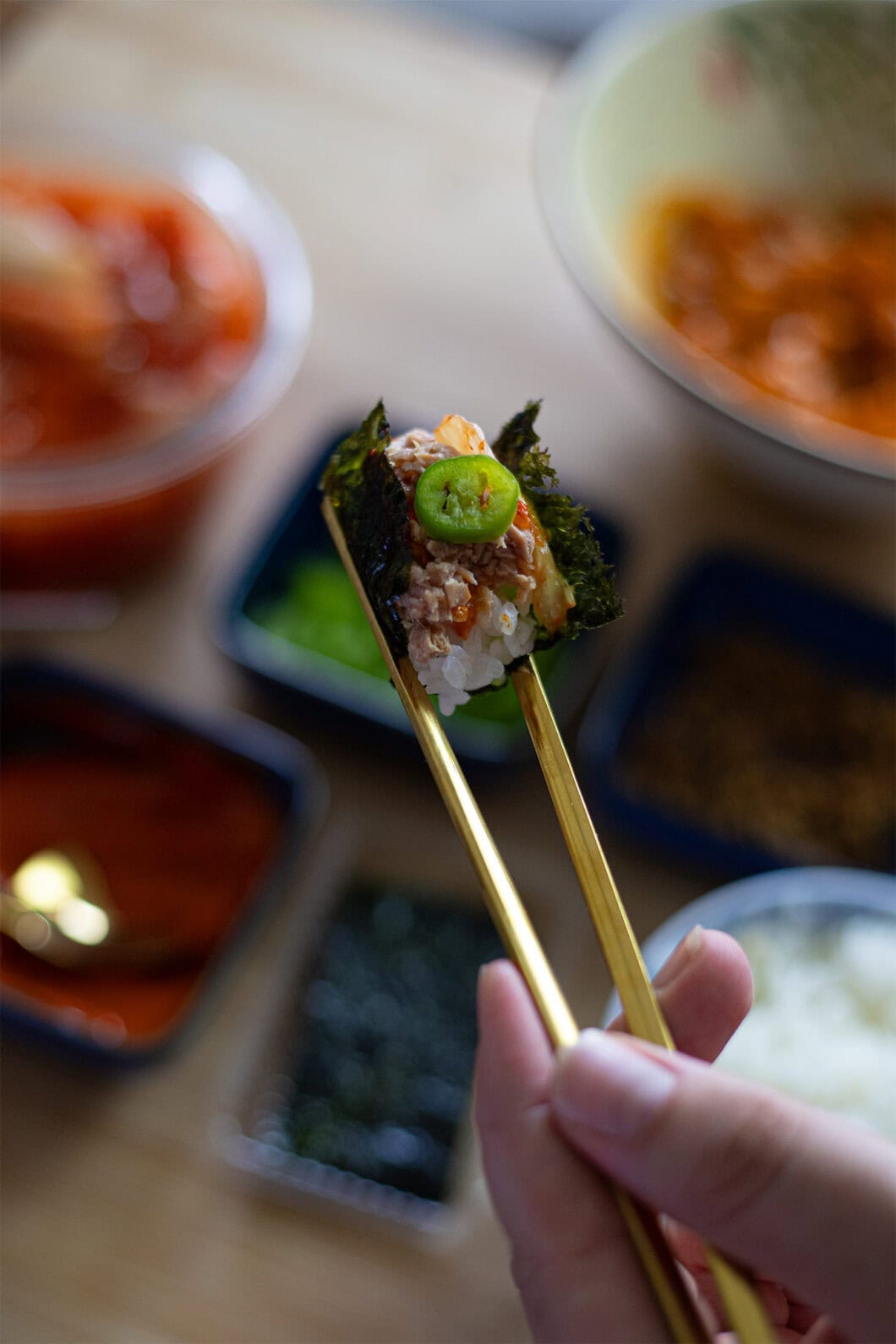 Spicy tuna bite wrapped in a small nori sheet