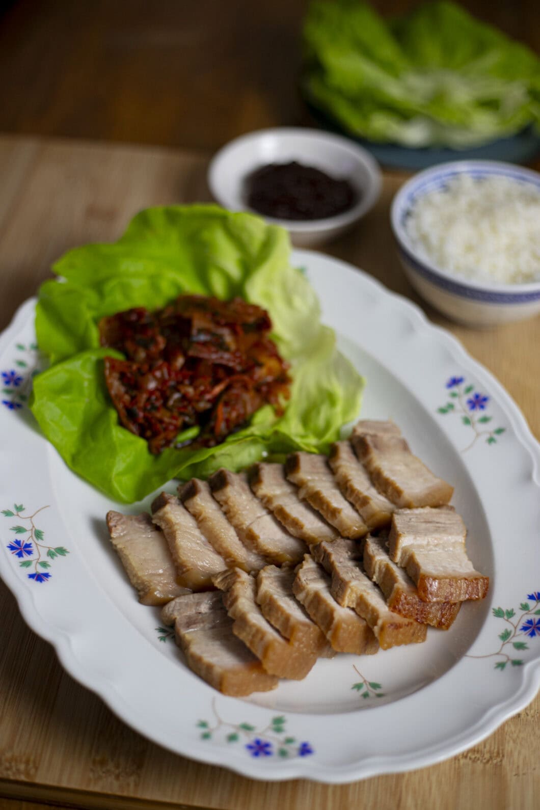 Easy Bossam, pork belly slices with kimchi, lettuce leaves, rice and ssamjang