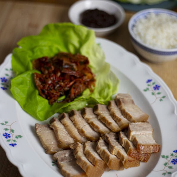 Easy Bossam, pork belly slices with kimchi, lettuce leaves, rice and ssamjang