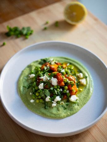 Peas, squash and feta on a bed of broccoli cream, topped with mint and parsley
