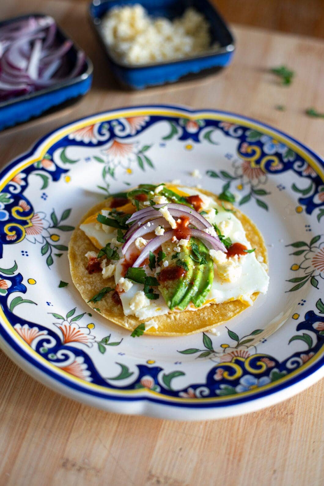 Egg & avocado veggie tacos with red onion, cilantro, hot sauce