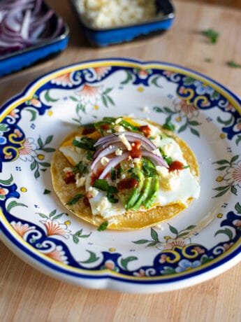 Egg & avocado veggie tacos with red onion, cilantro, hot sauce
