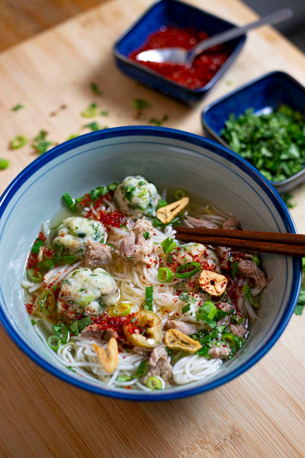 Thai fishball noodle soup with a clear broth, cilantro, green onion, garlic oil