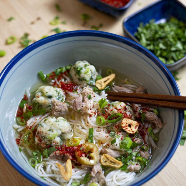 Thai fishball noodle soup with a clear broth, cilantro, green onion, garlic oil