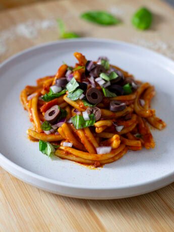 Nduja Pasta with a red onion, olive and basil topping