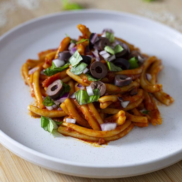 Nduja Pasta with a red onion, olive and basil topping