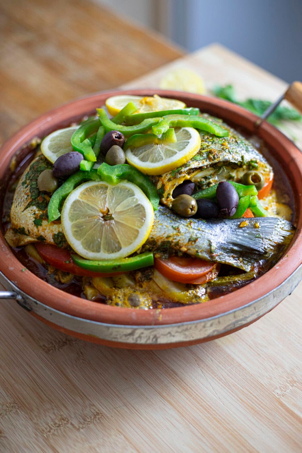 Sea bream tagine with vegetables, olives and lemon