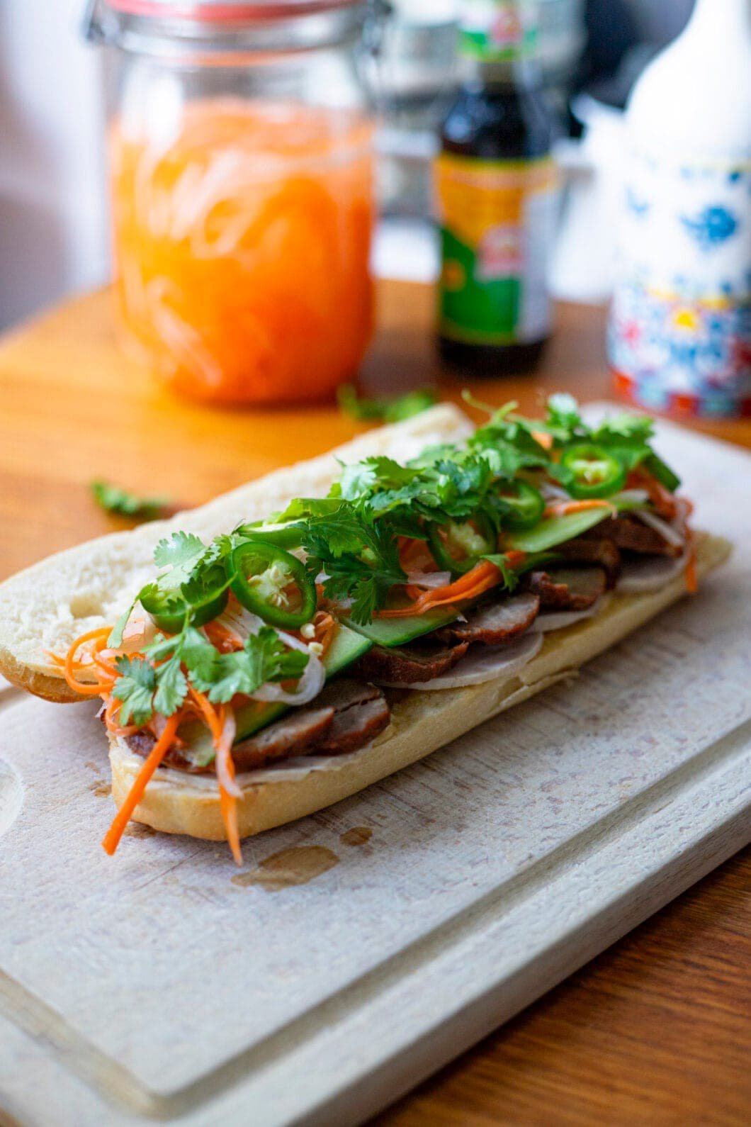 Char Siu Banh Mi in a baguette, with cilantro, Do Chua, green chilies and pâté