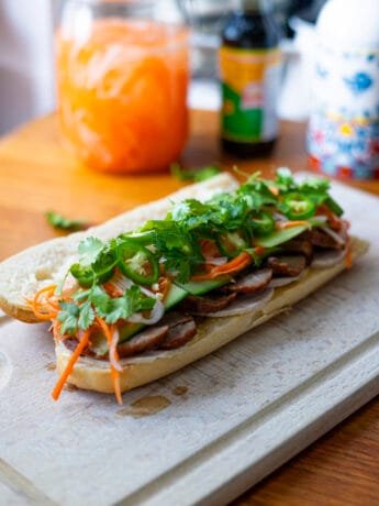 Char Siu Banh Mi in a baguette, with cilantro, Do Chua, green chilies and pâté