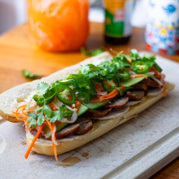 Char Siu Banh Mi in a baguette, with cilantro, Do Chua, green chilies and pâté