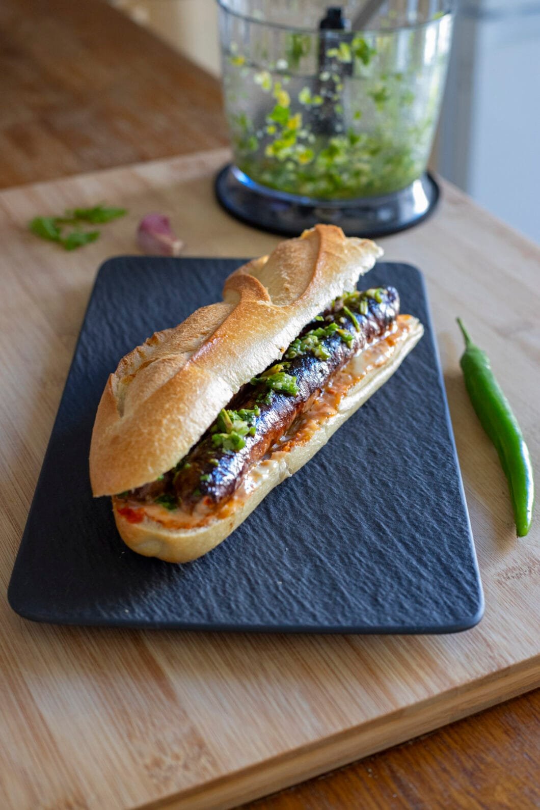 Merguez sandwich with harissa, mayo and green chili pepper condiment
