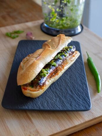 Merguez sandwich with harissa, mayo and green chili pepper condiment