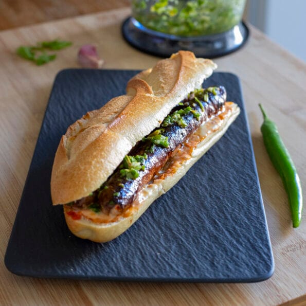 Merguez sandwich with harissa, mayo and green chili pepper condiment