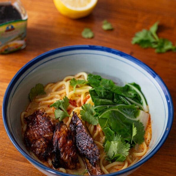 Red curry ramen with fresh noodles, cabbage, browned chicken and cilantro