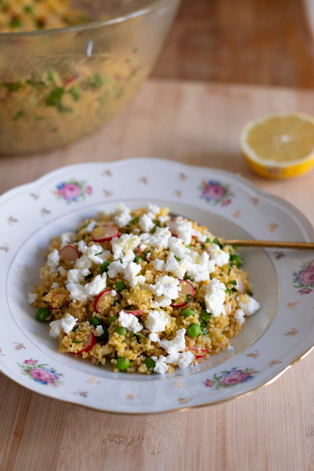 Veggie couscous salad with feta cheese, cucumber, radishes, peas
