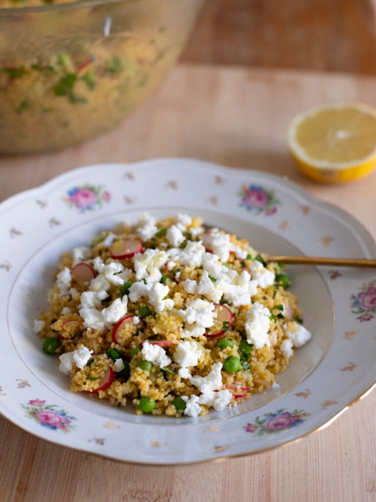 Veggie couscous salad with feta cheese, cucumber, radishes, peas