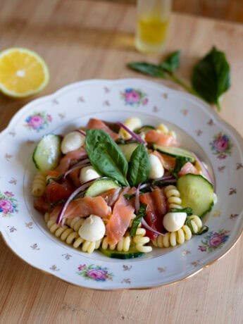 Salmon pasta salad with mozzarella, cucumber, tomatoes, red onions and basil