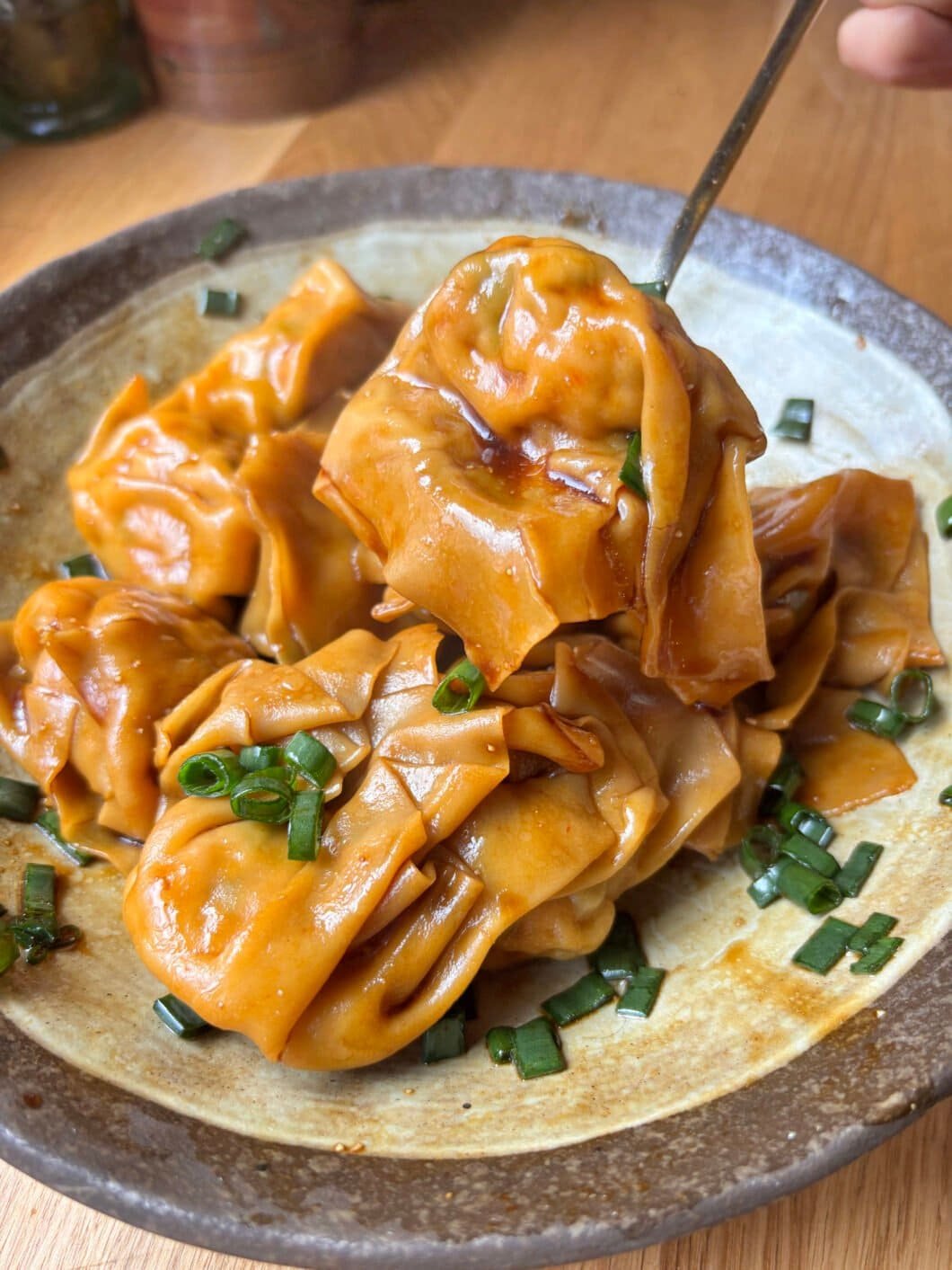 Juicy pork wontons tossed in a glossy soy sauce dressing with scallions. Fast, comforting and ridiculously satisfying.