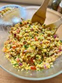 Couscous salad with onion, tomatoes, cucumber, chives and shrimps