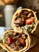 Beef tantuni in a lavash bread with tomatoes, onion and sumac, pickled peppers, parsley
