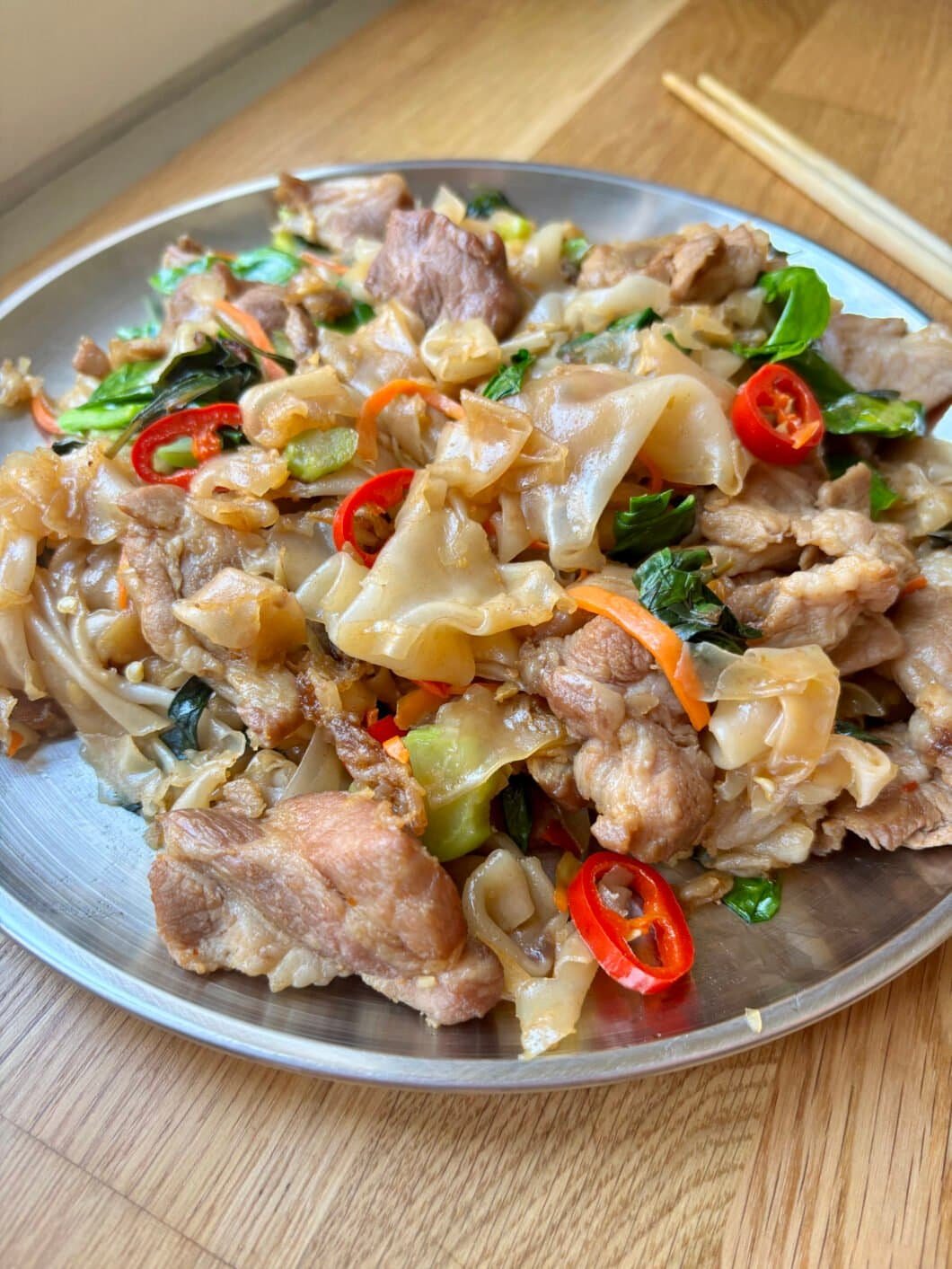Drunken noodles - wide noodles with pork, veggies and chilies