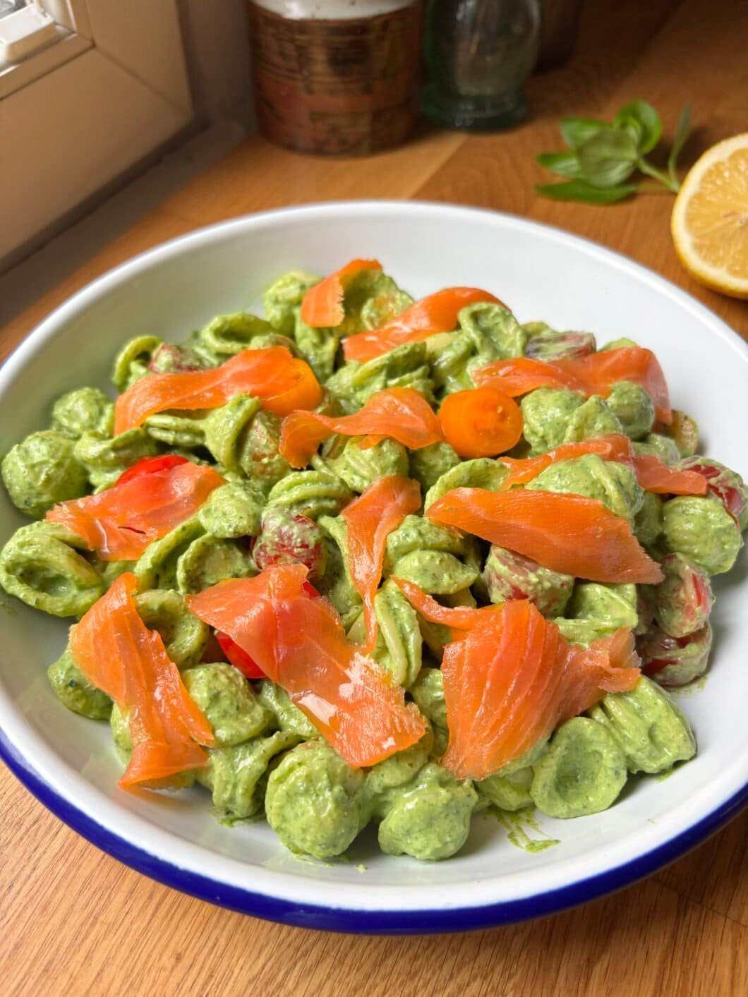 Orecchiette pasta coated in a spinach ricotta sauce topped with smoked salmon and cherry tomatoes