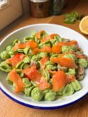 Orecchiette pasta coated in a spinach ricotta sauce topped with smoked salmon and cherry tomatoes