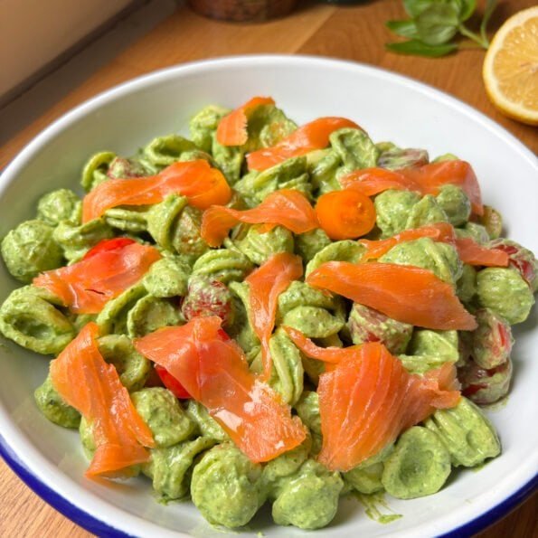 Orecchiette pasta coated in a spinach ricotta sauce topped with smoked salmon and cherry tomatoes