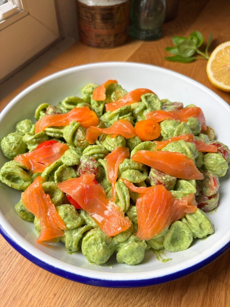Orecchiette pasta coated in a spinach ricotta sauce topped with smoked salmon and cherry tomatoes