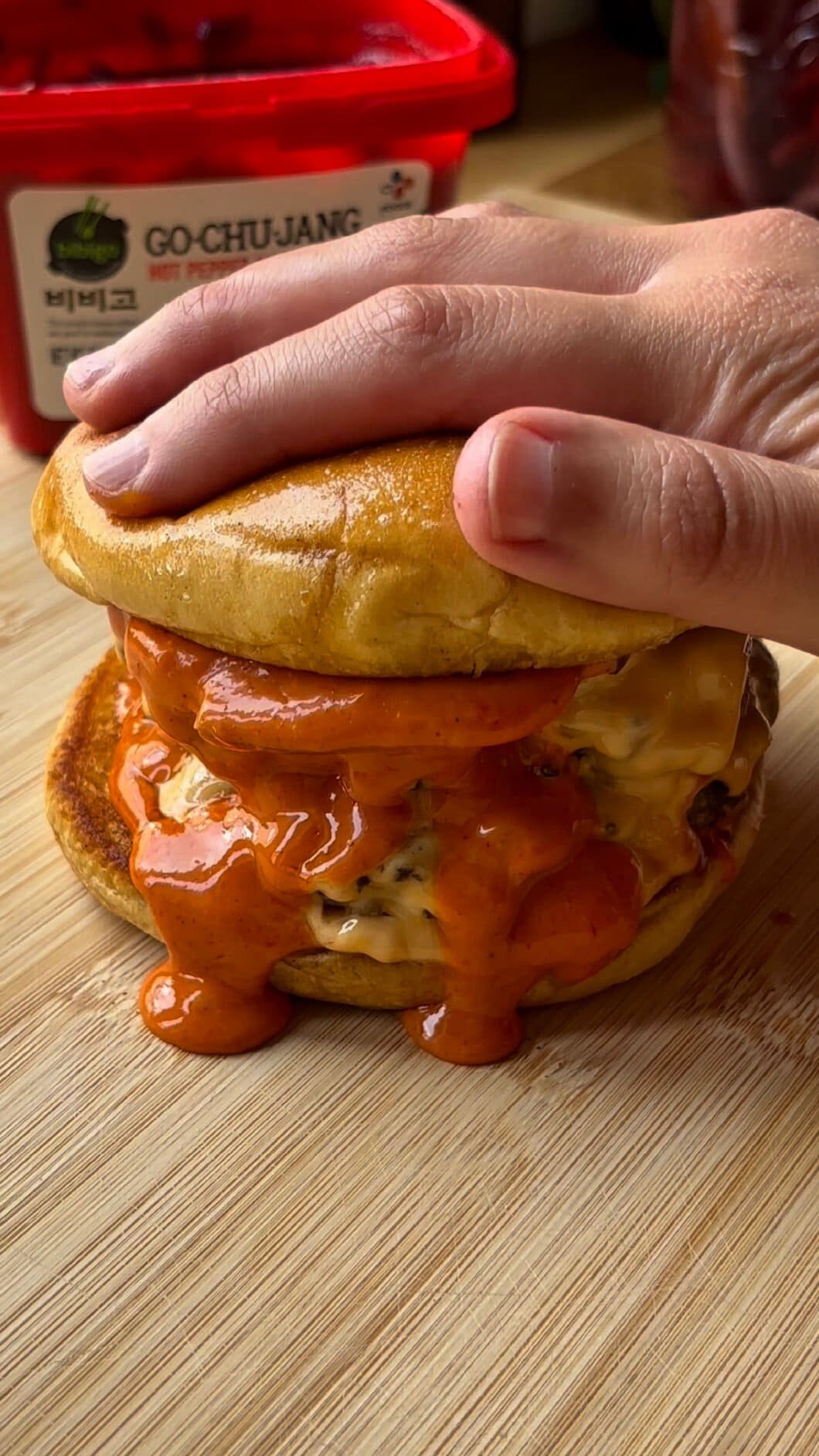 Spicy smash burger with two patties and lots of shiny Gochujang mayo