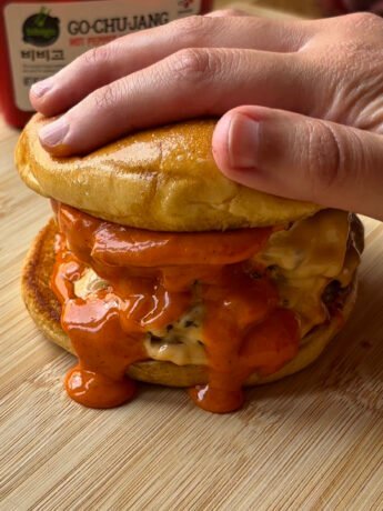 Spicy smash burger with two patties and lots of shiny Gochujang mayo