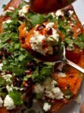 Veggie loaded sweet potato with feta cheese, lime and cilantro