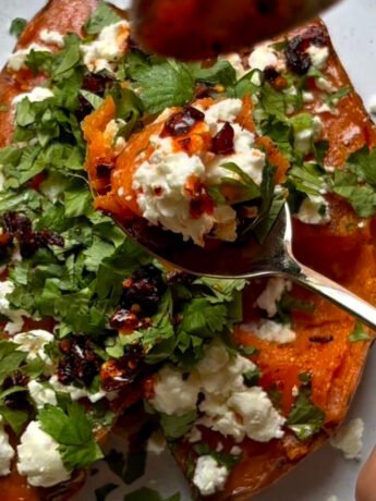 Veggie loaded sweet potato with feta cheese, lime and cilantro